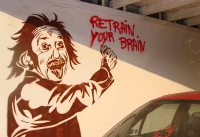 Banksy image of Einstein spraypainting Retrain Your Brain