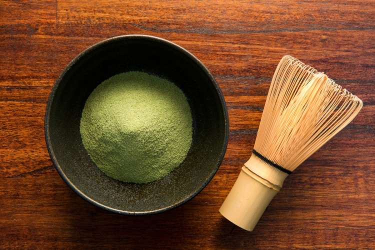 Image of green tea in a bowl with a traditional whisk