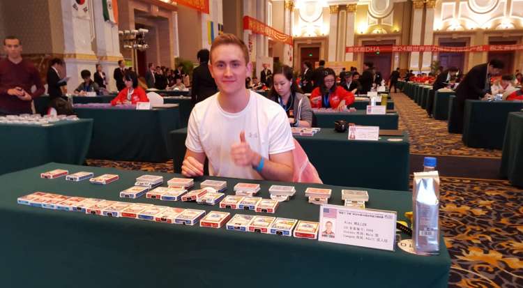 Alex Mullen at a table with multiple packs of playing cards