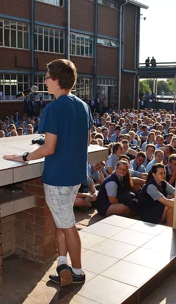 Portrait of Marno Hermann Reciting Pi From Memory In Front of a Crowd