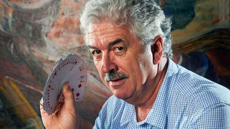 Dominic O'Brien with a deck of playing cards