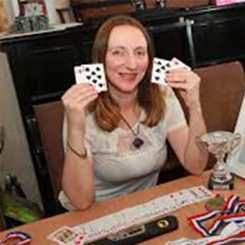 Katie Kermode with memory competition awards and playing cards