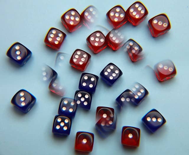 Image of blurred dice to express a concept related to the Cosmic Journal