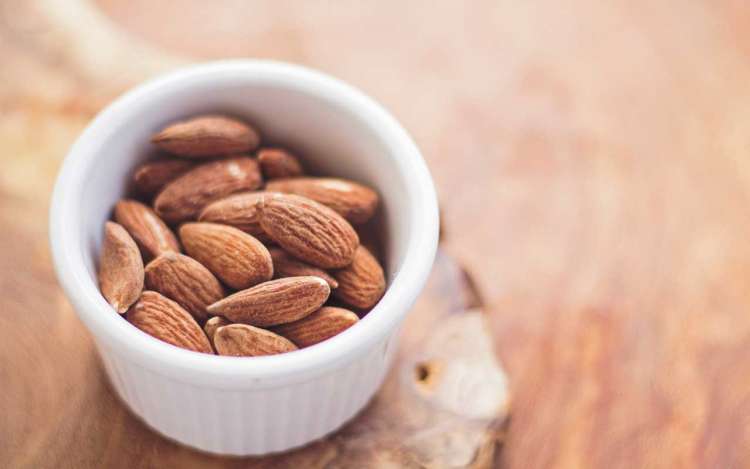 A bowl of almonds, which are high in Vitamin E.