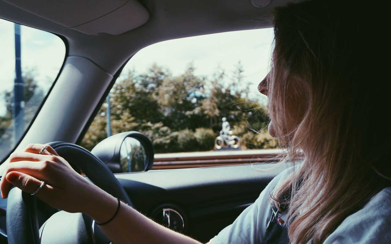 A woman driving a car; an example of a type of implicit memory.