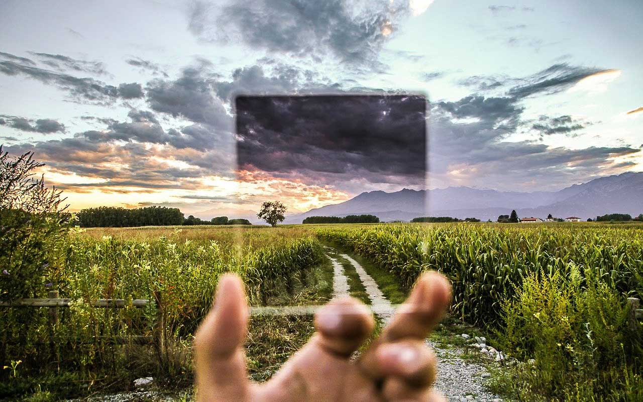 The filter of selective attention, like this picture of a filter looking out over a cornfield with mountains in the distance