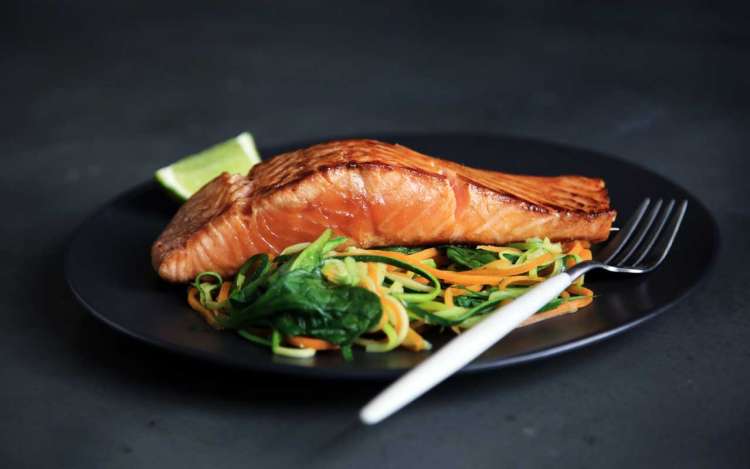 Salmon and vegetables on a plate, part of a memory-healthy diet.