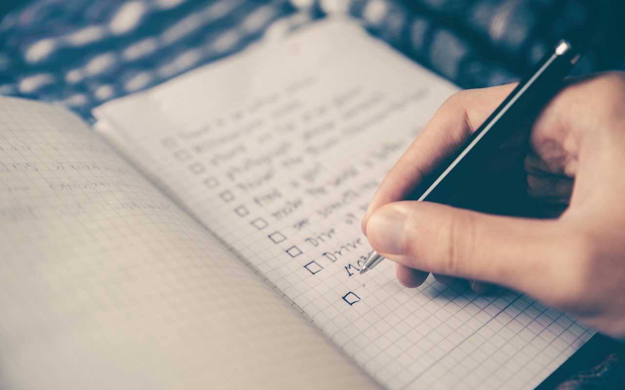 A person makes a checklist. One way to get your habits going and growing.