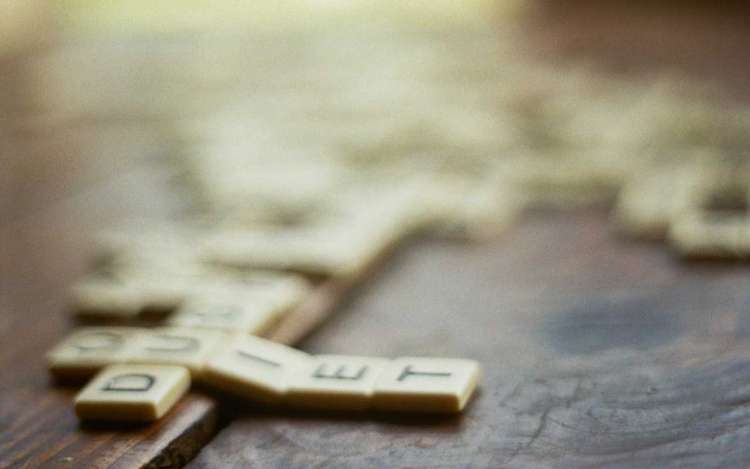 Scrabble tiles on a table, an example of games that can stimulate your brain.