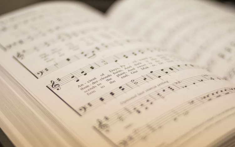 A book of sheet music open to a song.
