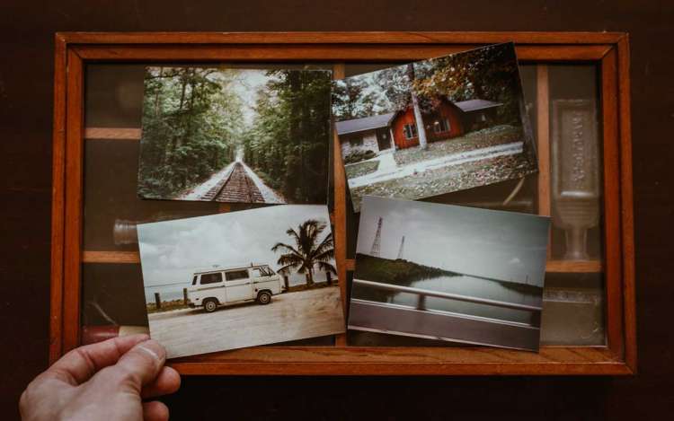 A shadow-box with four travel photos sitting on top.
