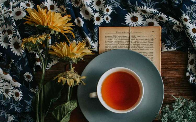 A cup of tea, an open book, and a few sunflowers. You can "sip" your tea, and take it one SIP (study, implement, practice) at a time.