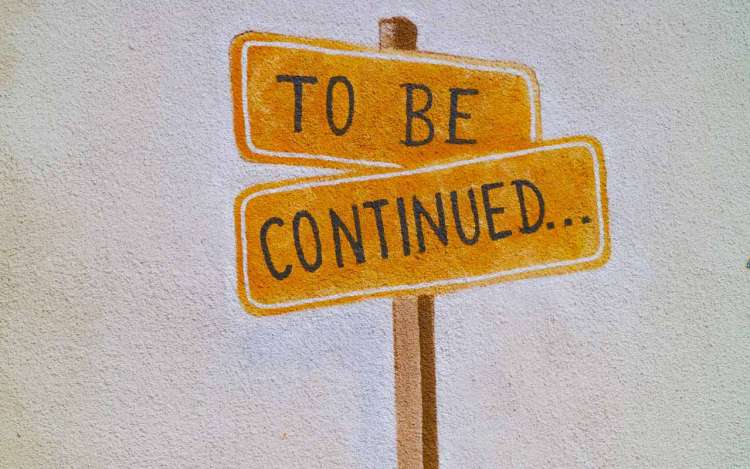 Hand painted "to be continued" signs against a white background.