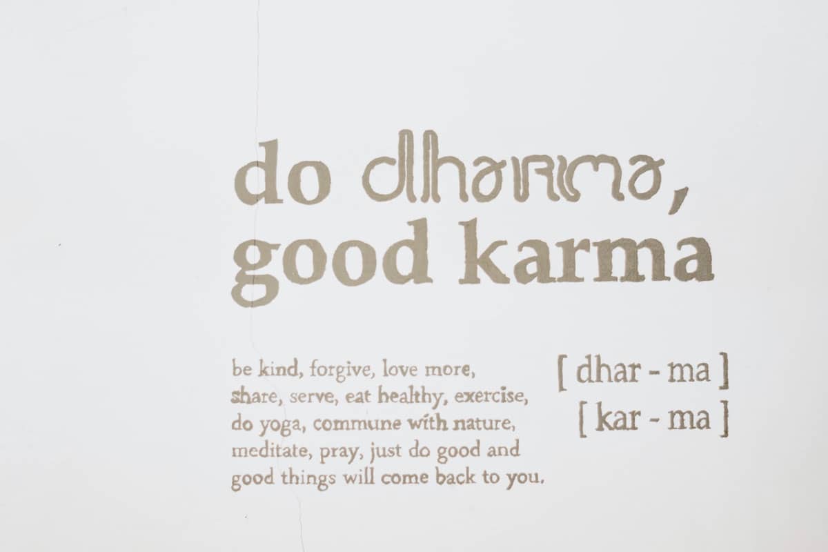 A painted sign stating "do dharma, good karma."
