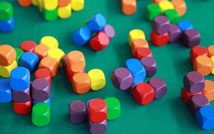 A stack of colorful magnetic building blocks. Long-term memory can be improved by combining memory techniques.