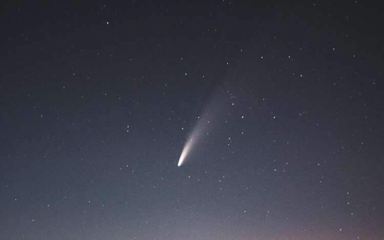A comet streaks across a darkened sky. Using Halley's comet to remember the name Haley is a way to help you remember names.