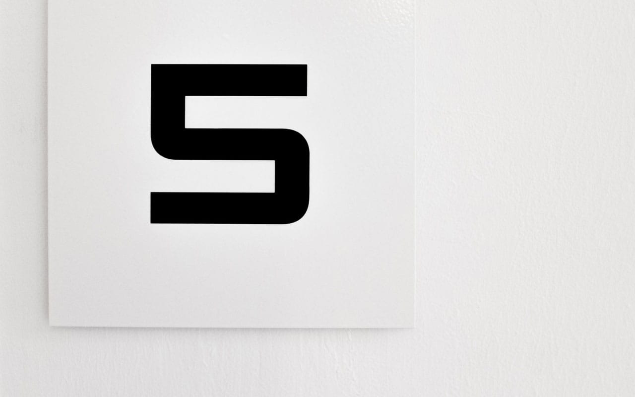 The number five, printed in black lettering on a white background. The five stages of language fluency are described below.