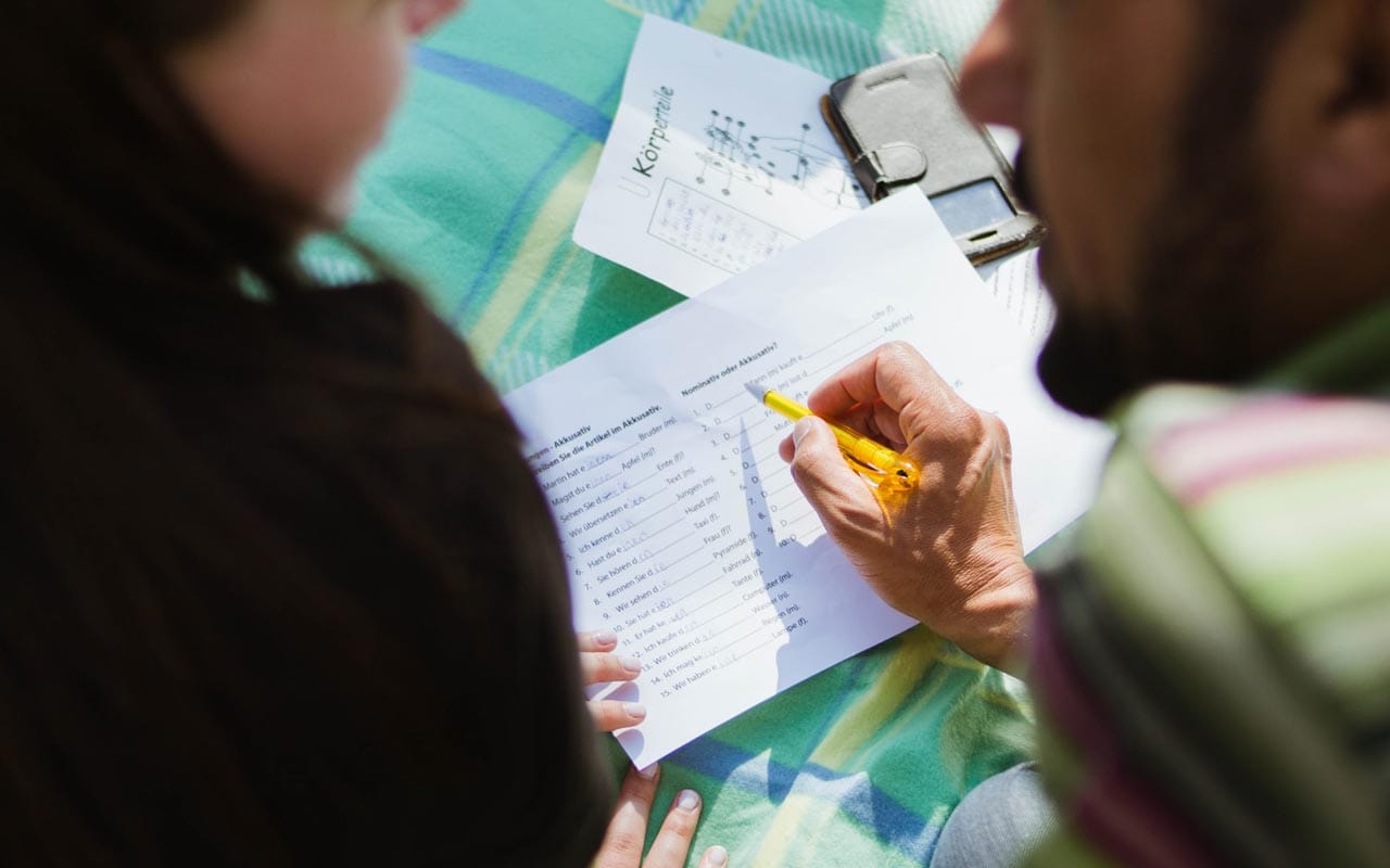 A language teacher looks over a worksheet with a student.