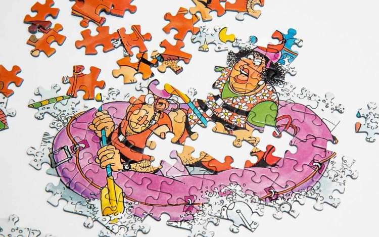 An incomplete jigsaw puzzle of a cartoon couple in an inflatable pink raft.