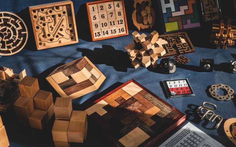 Wooden puzzles sit on a table. Brain games can help boost your memory (just not the ones on your smartphone).
