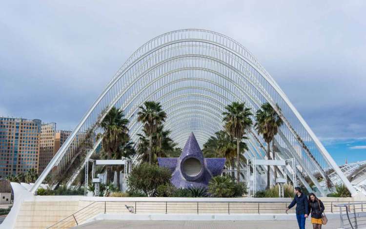 A couple walks by The Umbracle in Valencia, Spain.