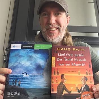 Anthony Metivier reading books in Chinese and German