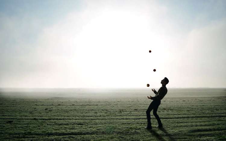 a man juggling with three balls