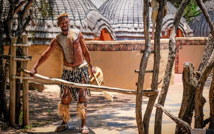 a man in tribal clothes expressing a concept related to cultural and historical knowledge