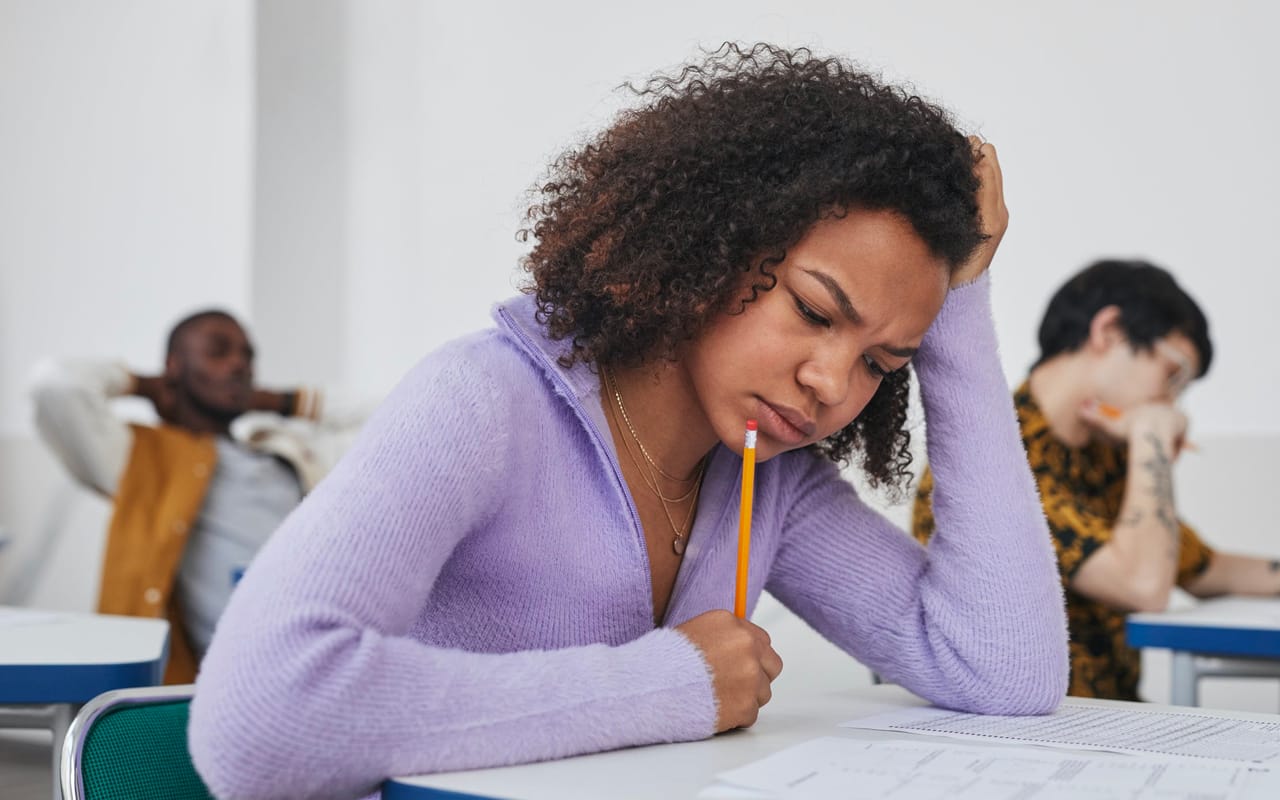 a woman is struggling in an exam