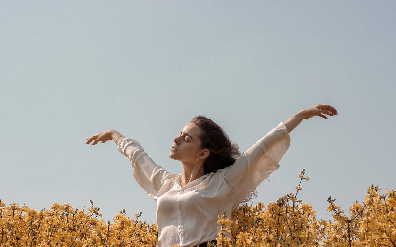 a woman feeling free in a field