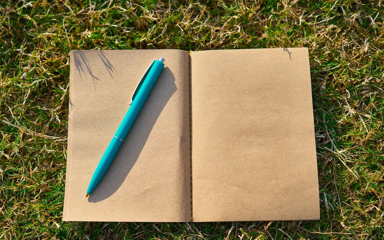 a blank note book and a pen