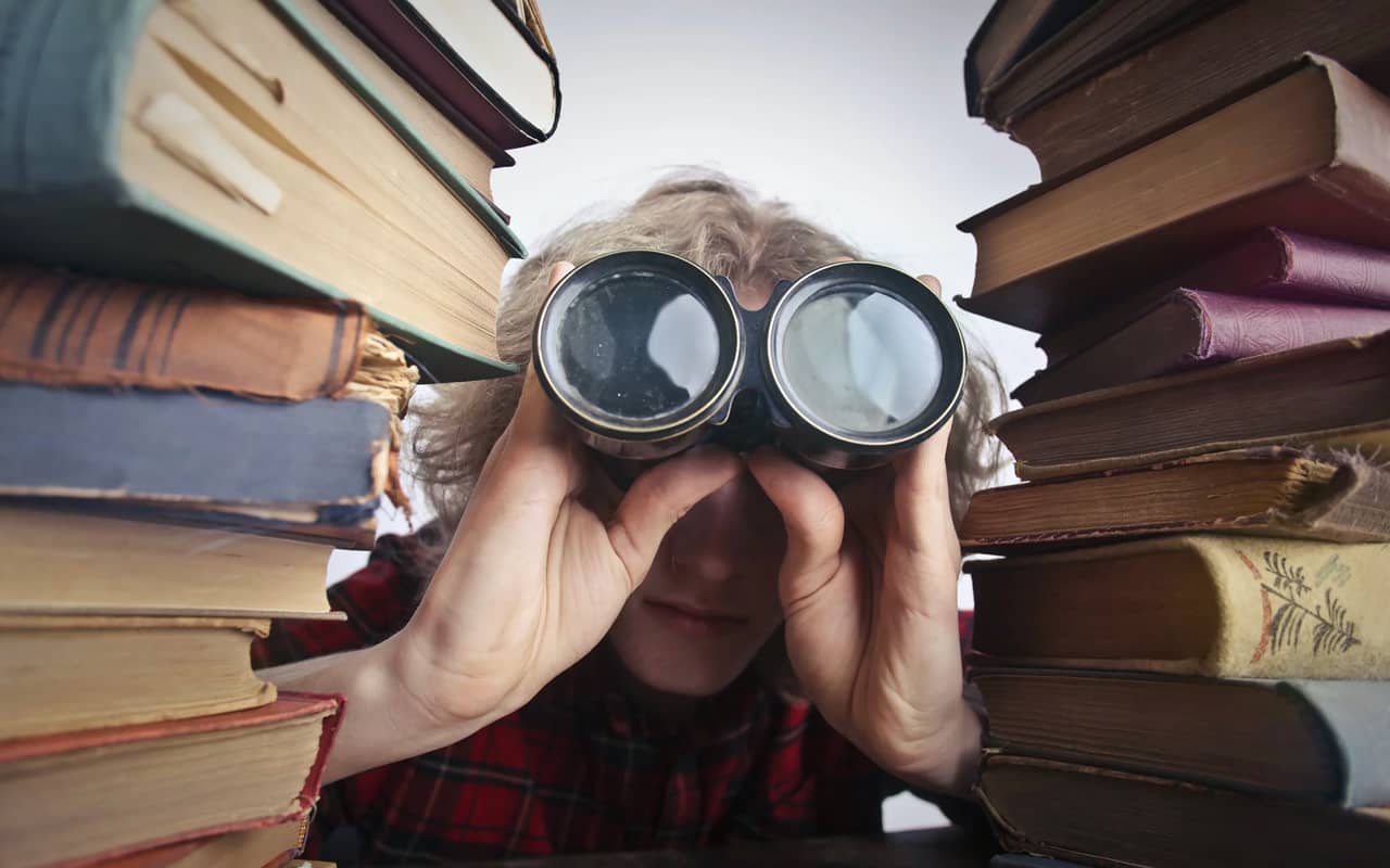 a person uses telescope between books