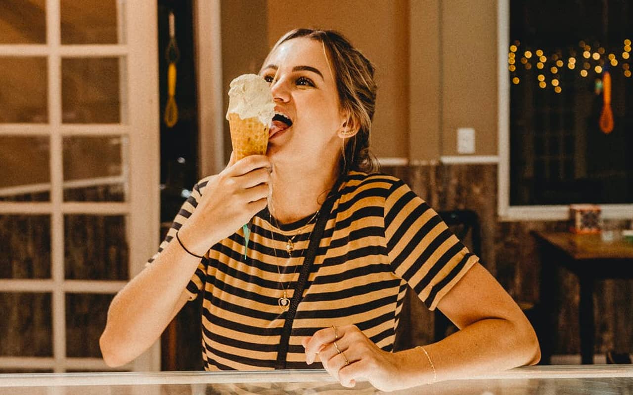 a woman is eating ice cream
