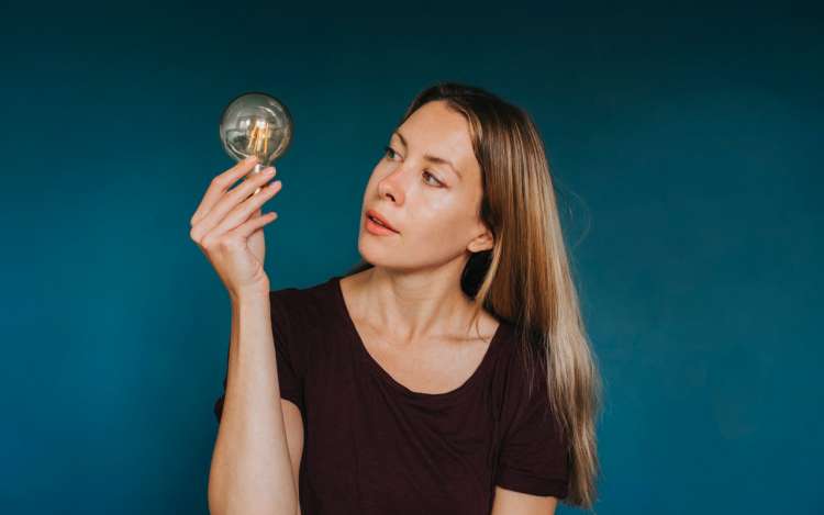 a woman is holding a light bubble