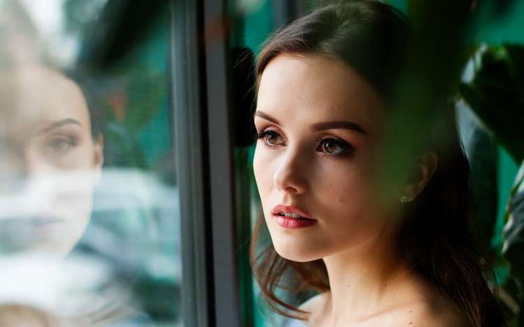 a woman beside a window