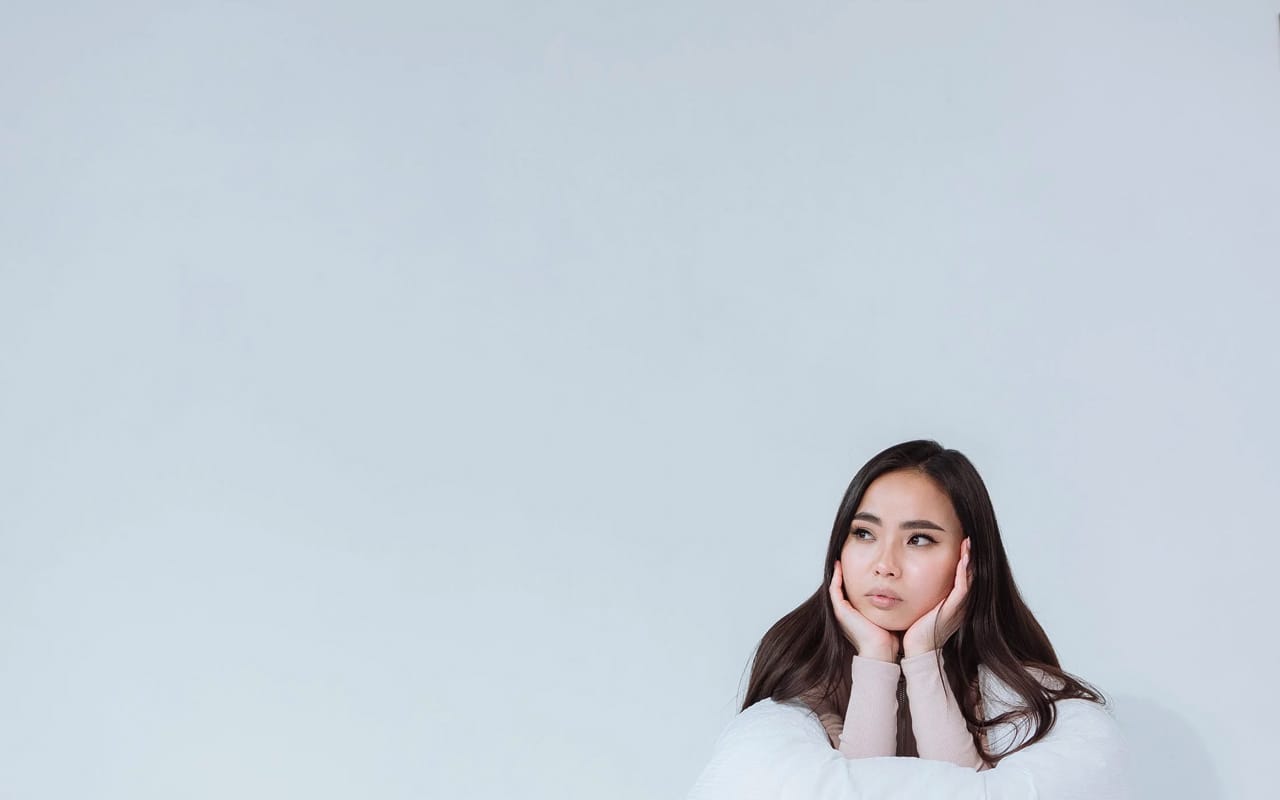 a woman is thinking with white background
