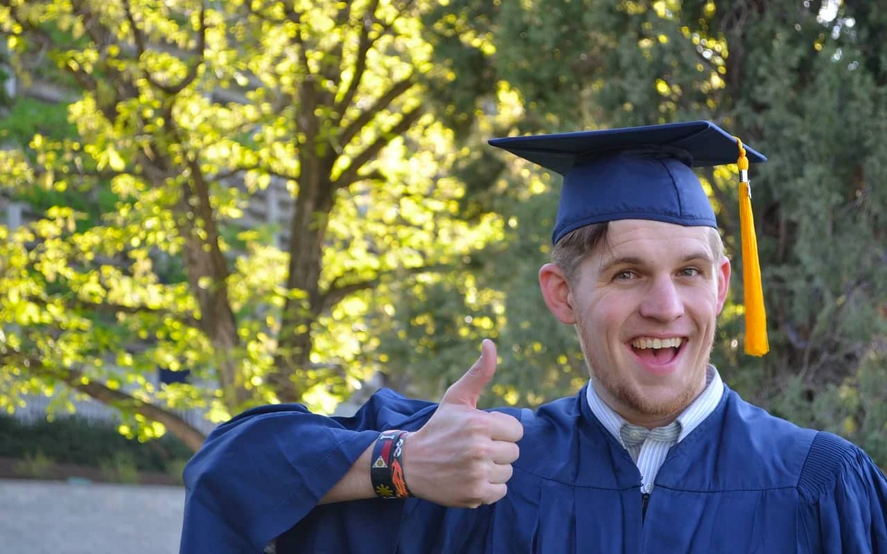 a man graduated with a big smile