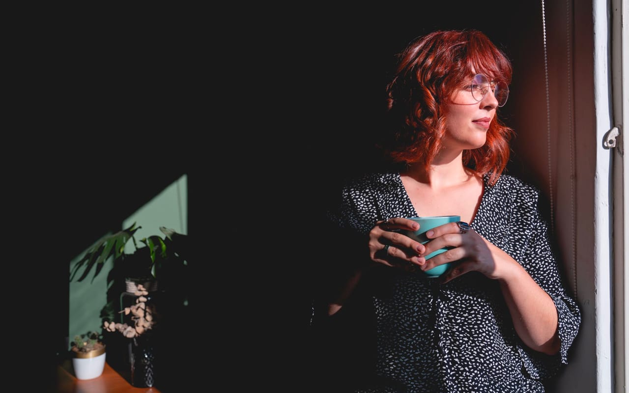 a woman has a green cup in her hands