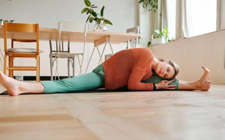 a woman is stretching on the floor