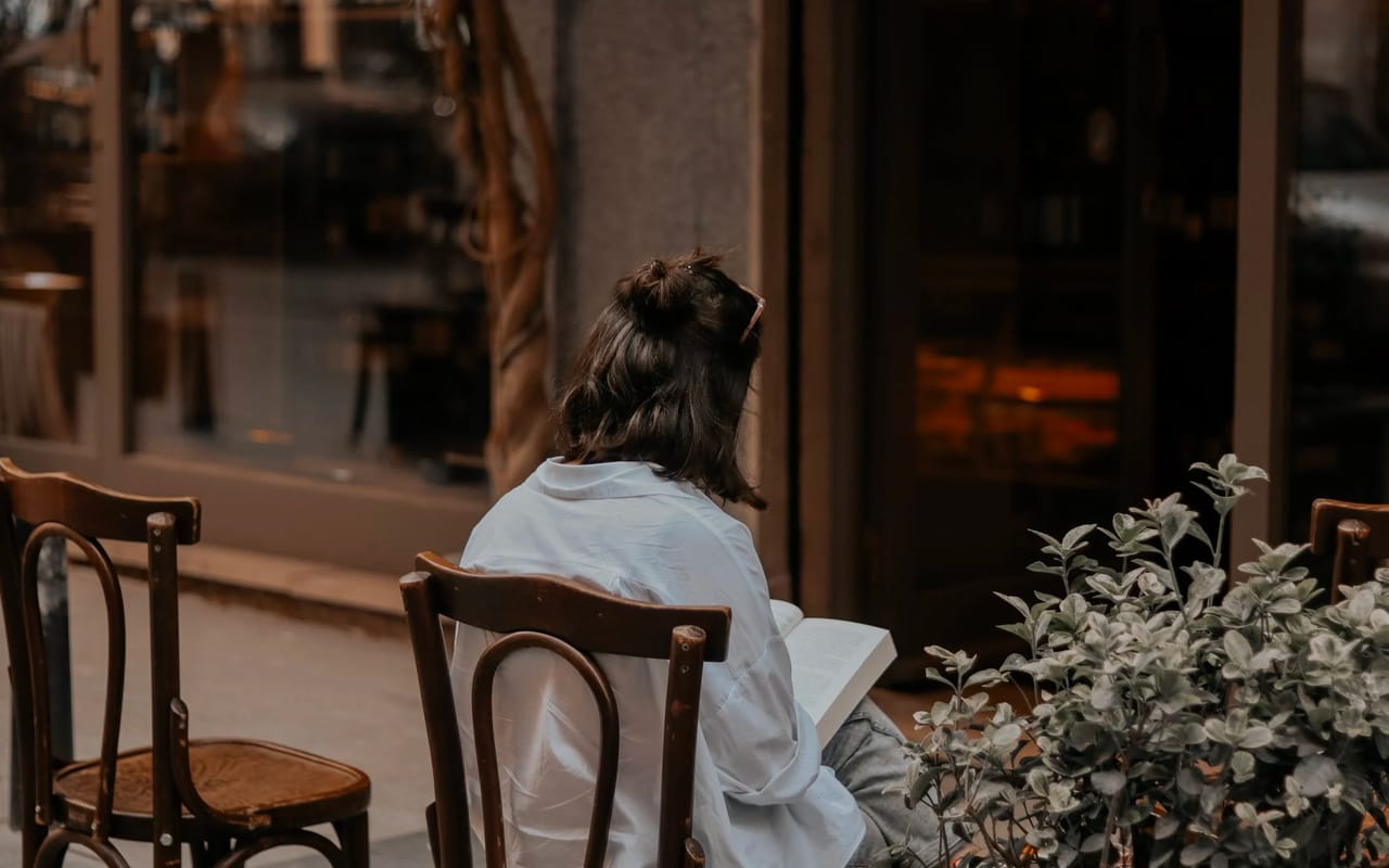 back side image of a reading woman