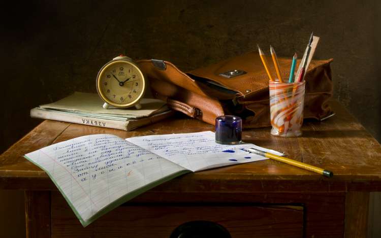 hand writing on a wooden desk