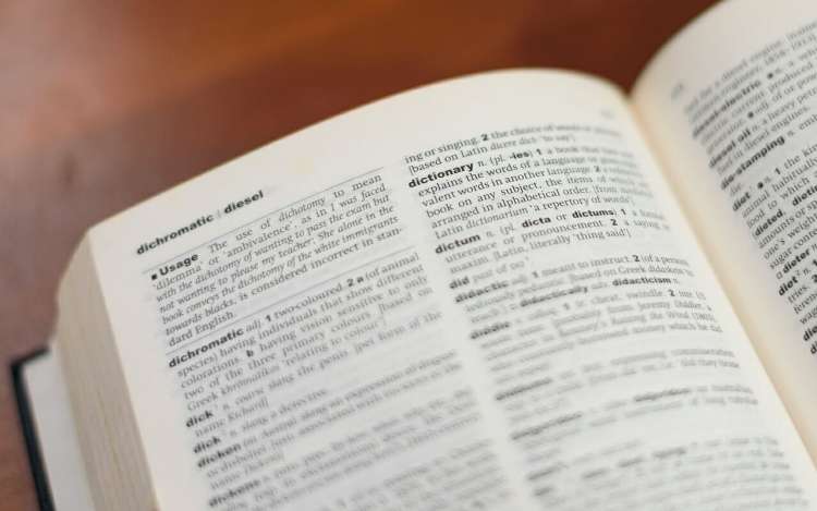 a dictionary on a wooden desk