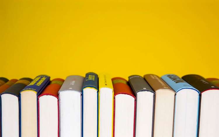 books in front of a yellow background