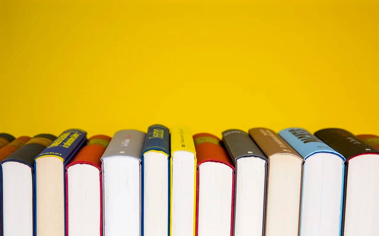 books in front of a yellow background
