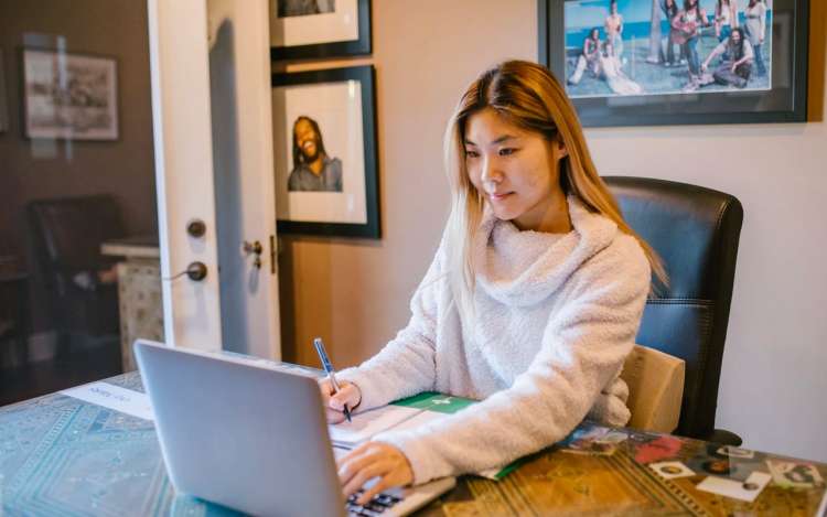 long hair asian woman is learning with her laptop