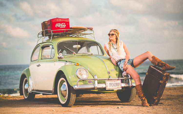 a woman is sitting on her green car