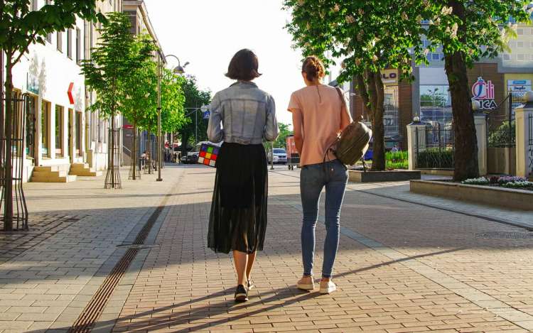 women are walking on a street