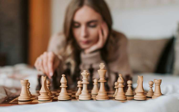a woman is playing chess