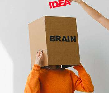 linguistic intelligence feature image of a hand adding an idea to a box labelled brain
