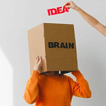 linguistic intelligence feature image of a hand adding an idea to a box labelled brain